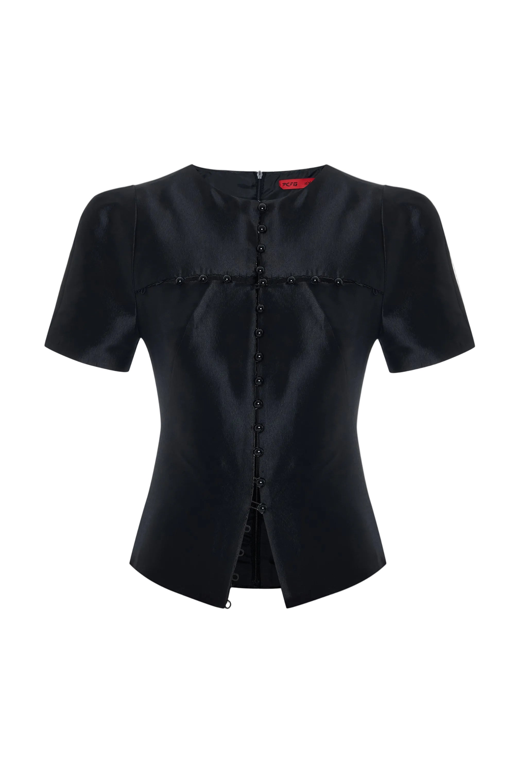 Black blouse with ruffled details on a light gray background